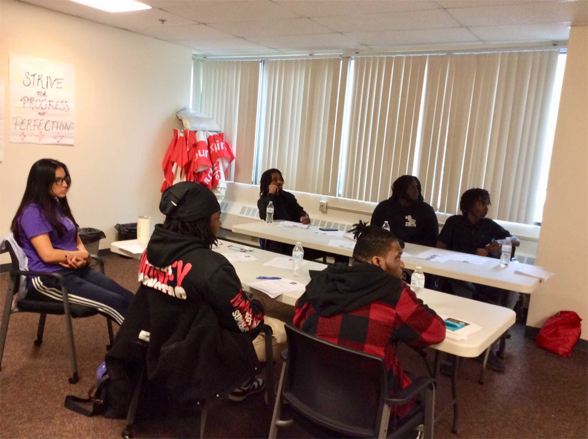 FLAG participants engaged in a group discussion around the table