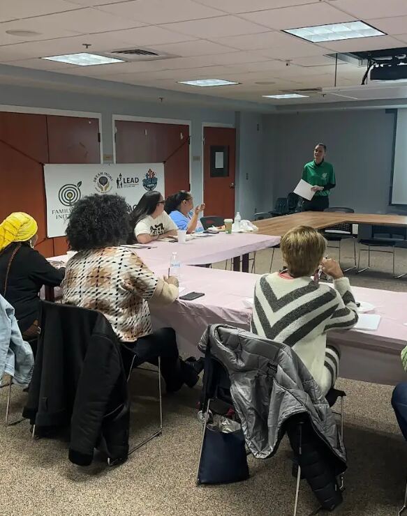 Workshop attendees listening to a Family First Initiative speaker