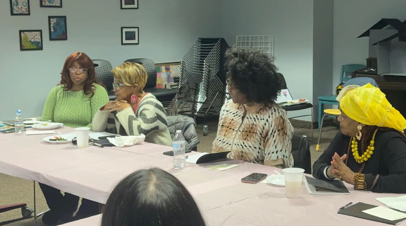 Community members in conversation around a Family First table