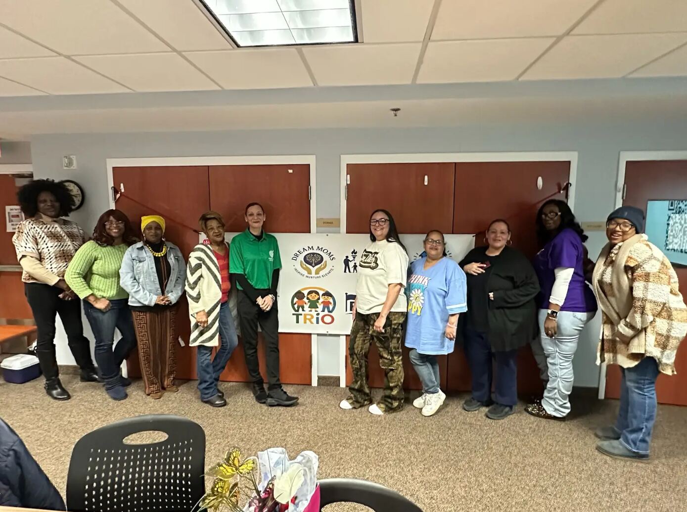 Group photo with Dream Moms, LEAD, and TRiO program banners